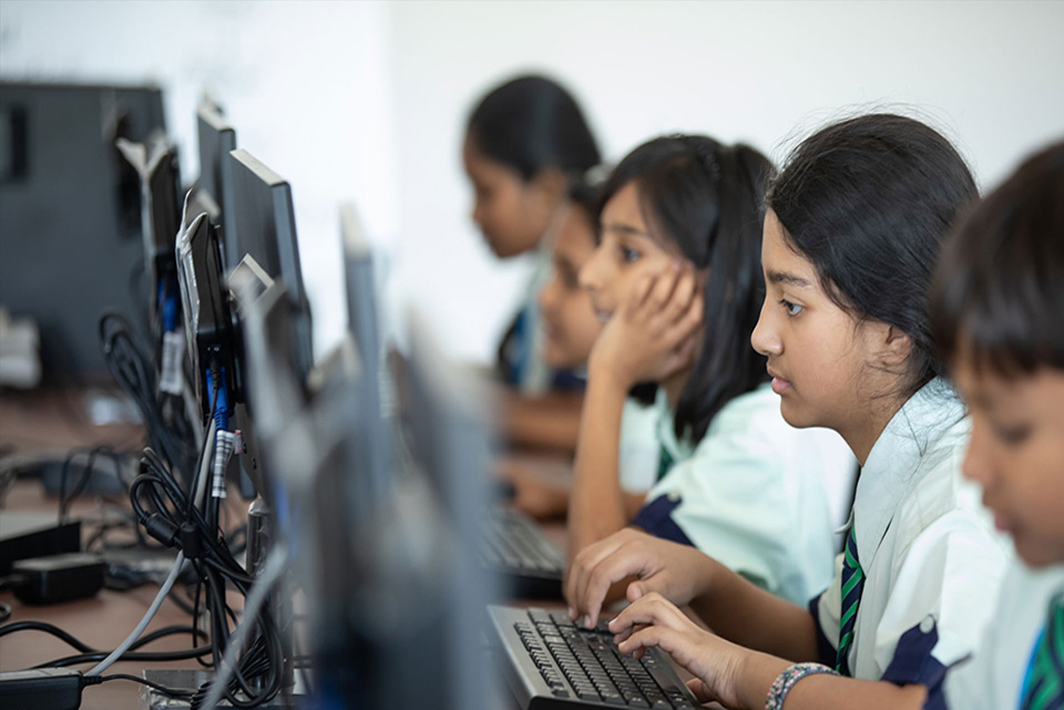 Young women learning computer skills in a classroom